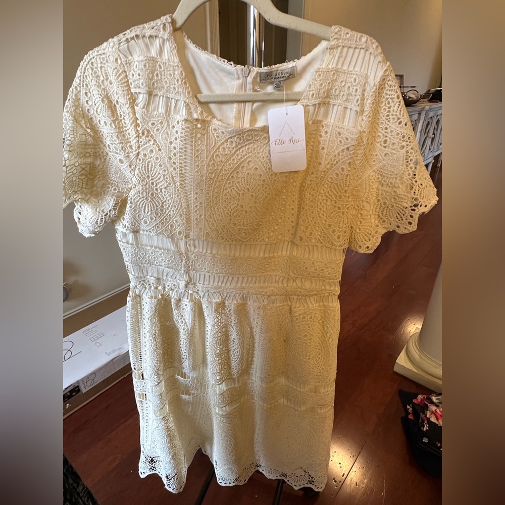 Short sleeve cream dress with crochet overlay. Perfect for bridal occasions.